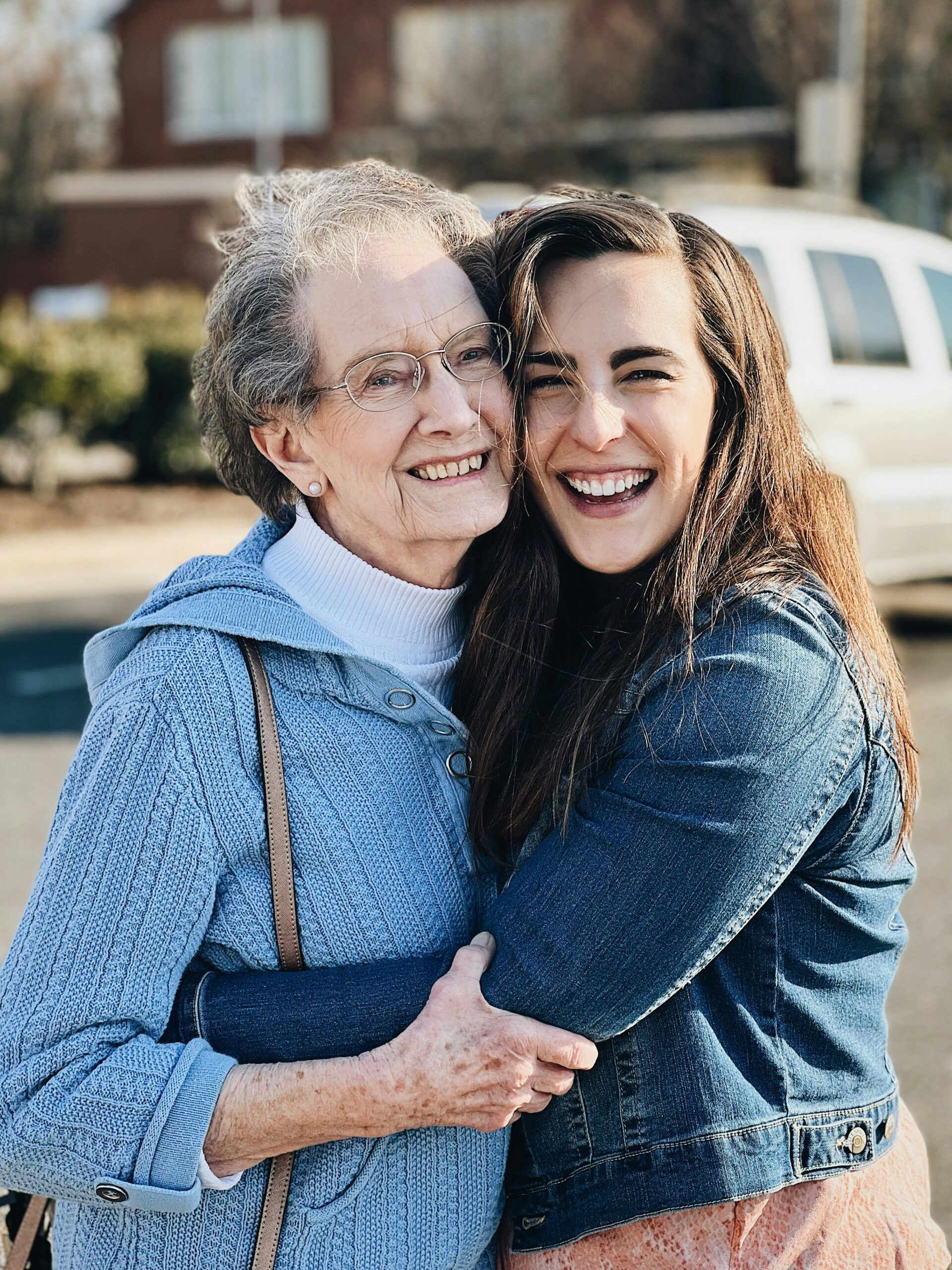 older woman hugging younger woman